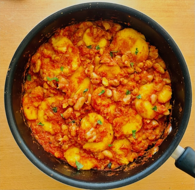 Polenta with cannellini beans in a tomato sauce.