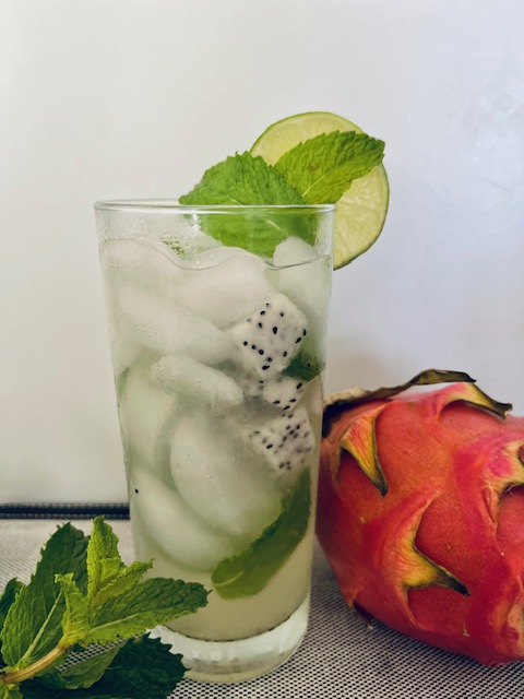 Dragon fruit mojito mocktails garnished with lime, jackfruit, and mint