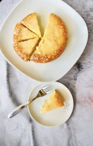 Almond ricotta cake topped with orange icing