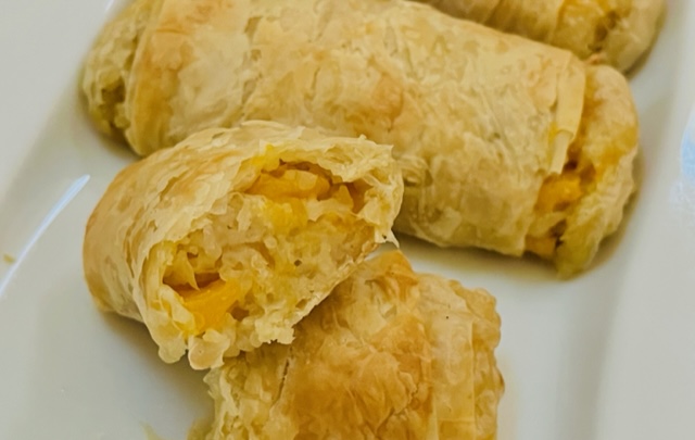 Mango sticky rice rolls, broken in half and shown from the front.