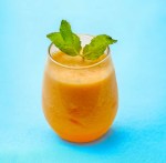 Cantaloupe mint coolers garnished with a fresh mint sprigs