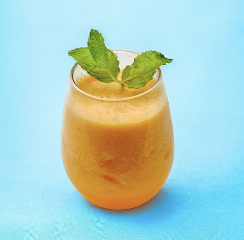 Cantaloupe mint coolers garnished with a fresh mint sprigs