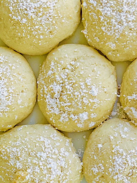 Ricotta cookies topped with confectioners sugar.